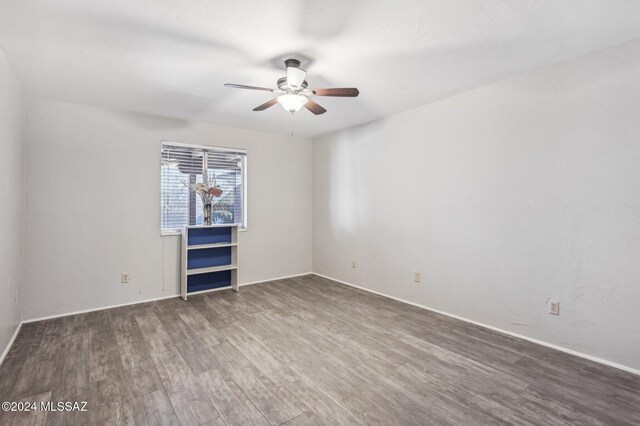611 S Los Opalos, Green Valley, AZ 85614 - empty room featuring ceiling fan, wood finished floors, and baseboards