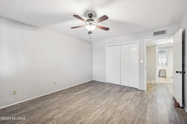 611 S Los Opalos, Green Valley, AZ 85614 - unfurnished bedroom featuring wood finished floors, a closet, baseboards, and ceiling fan