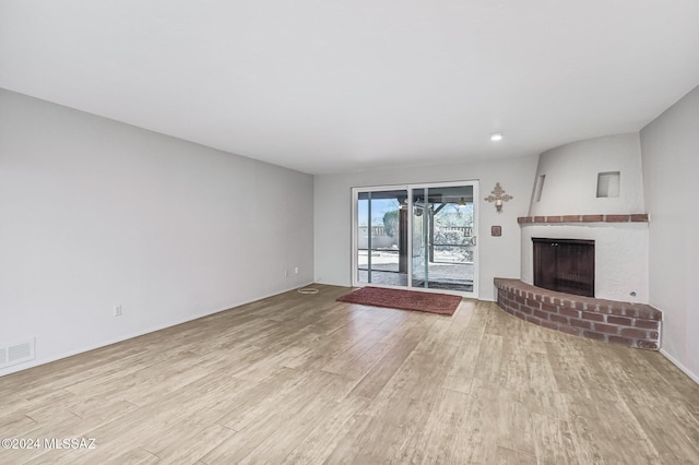 611 S Los Opalos, Green Valley, AZ 85614 - unfurnished living room featuring wood finished floors and a fireplace