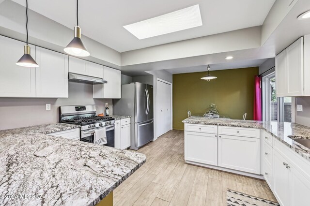 611 S Los Opalos, Green Valley, AZ 85614 - kitchen with stainless steel appliances, under cabinet range hood, a peninsula, white cabinetry, and light stone countertops