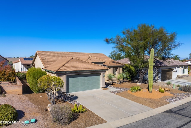 1955 E E Clf, Swallow Trail, Green Valley, AZ 85614 - view of front of home with an attached garage, stucco siding, driveway, and a tile roof
