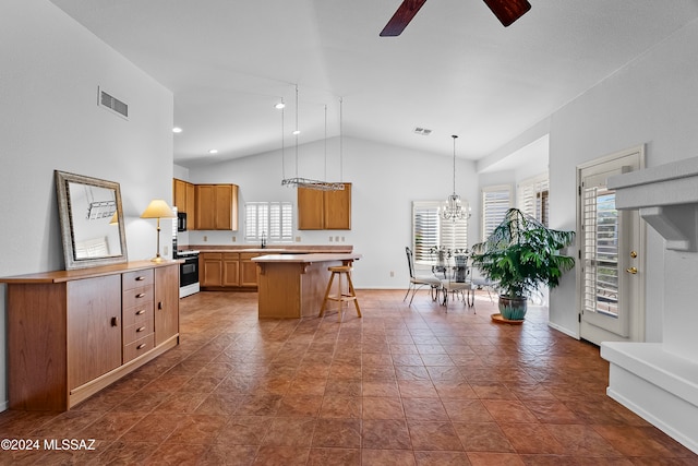 kitchen featuring a kitchen island, white stove, a wealth of natural light, and vaulted ceiling