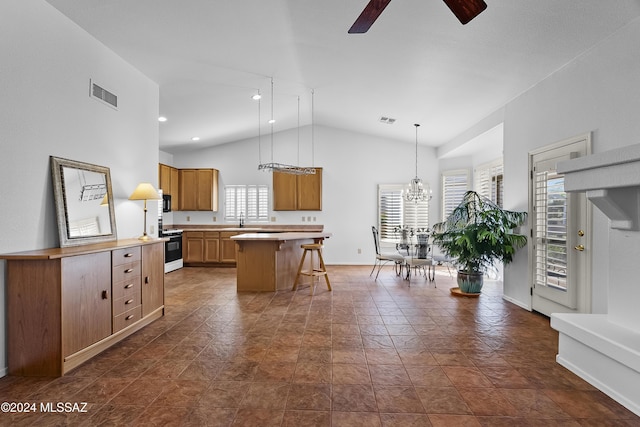 1955 E E Clf, Swallow Trail, Green Valley, AZ 85614 - kitchen with ceiling fan, a breakfast bar area, a sink, range with gas cooktop, and a chandelier