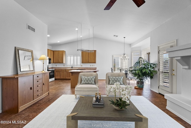 living room featuring ceiling fan with notable chandelier, lofted ceiling, sink, and dark wood-type flooring