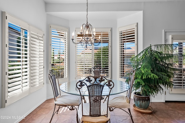 tiled dining space featuring a chandelier and a wealth of natural light