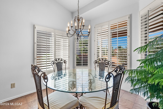 dining space with plenty of natural light, light tile patterned floors, and a chandelier