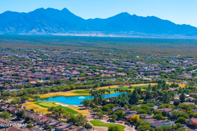 birds eye view of property with a water and mountain view