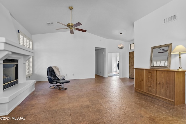 1955 E E Clf, Swallow Trail, Green Valley, AZ 85614 - unfurnished living room with a glass covered fireplace, high vaulted ceiling, ceiling fan, and baseboards