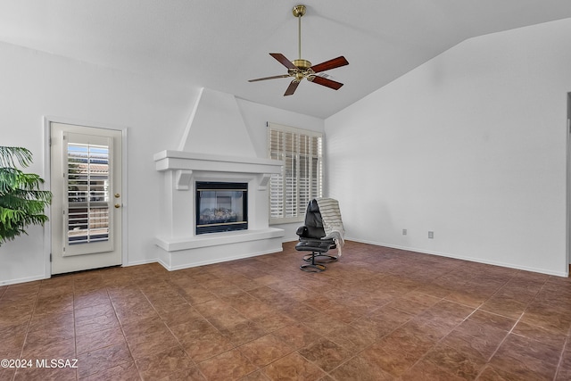 1955 E E Clf, Swallow Trail, Green Valley, AZ 85614 - unfurnished living room featuring vaulted ceiling, ceiling fan, a large fireplace, and baseboards