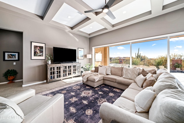 living room with beam ceiling, a wealth of natural light, hardwood / wood-style floors, and coffered ceiling