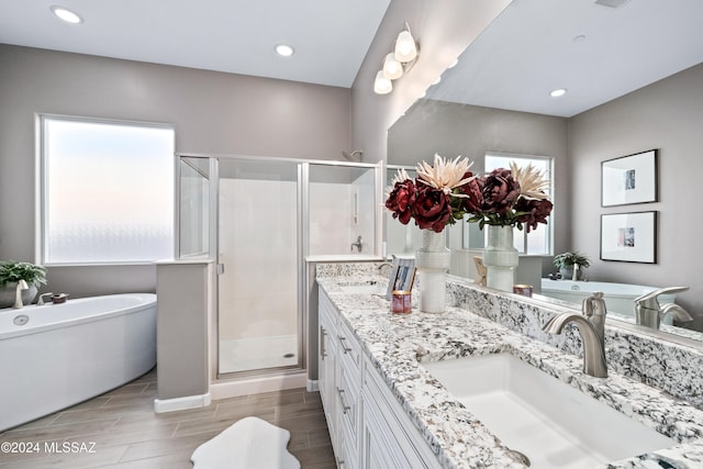 bathroom with hardwood / wood-style flooring, vanity, and independent shower and bath