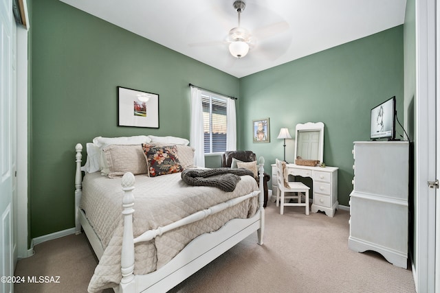 bedroom with ceiling fan and light carpet