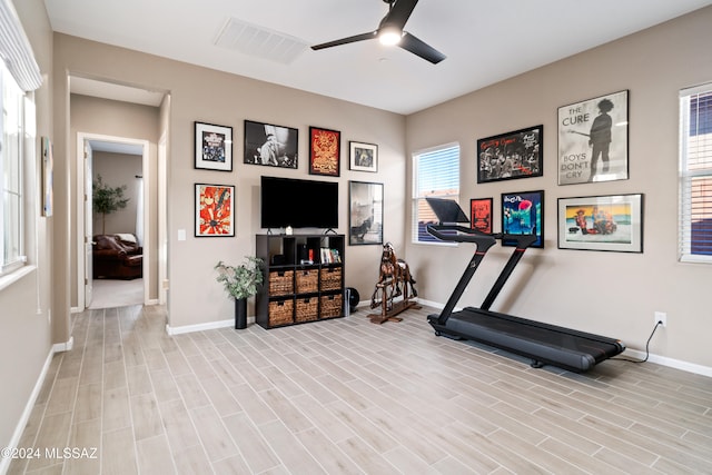 workout room with light hardwood / wood-style floors and ceiling fan