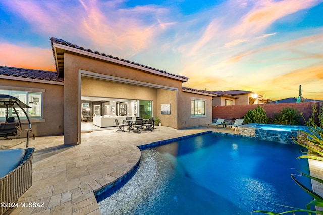 pool at dusk with a patio