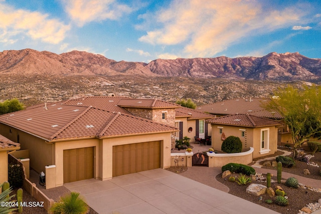 mediterranean / spanish-style house with a mountain view and a garage