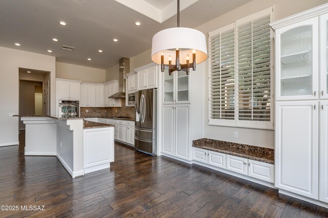 kitchen with dark stone counters, beverage cooler, sink, white cabinets, and dark hardwood / wood-style floors