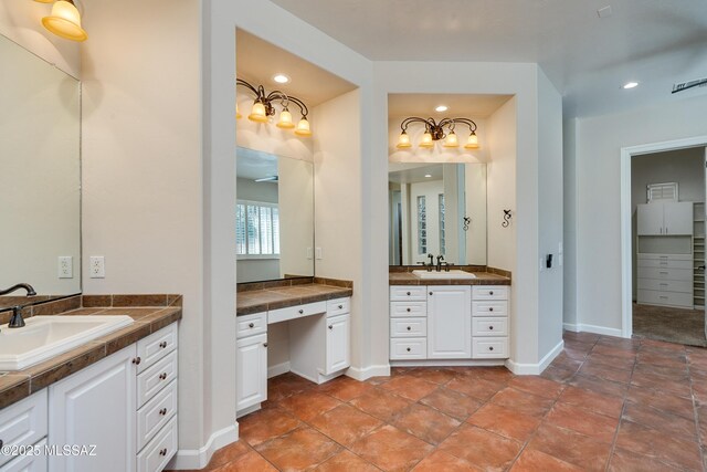 bathroom featuring vanity, ceiling fan, and tiled tub