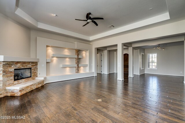 living room with a mountain view, a fireplace, ceiling fan, and wood-type flooring