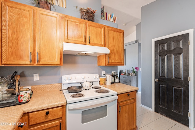 kitchen with light tile patterned floors and white range with electric cooktop