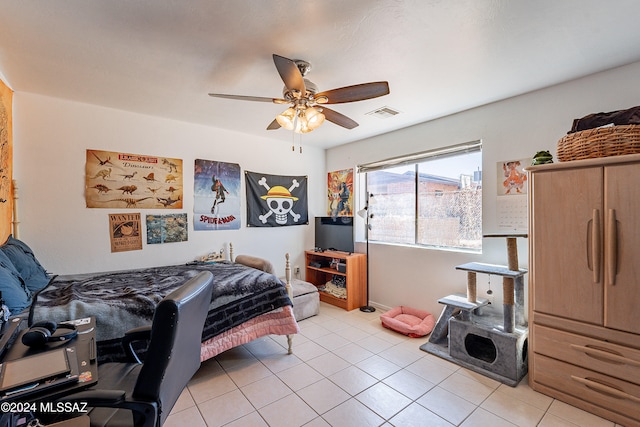 tiled bedroom featuring ceiling fan