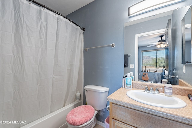 full bathroom with shower / bathtub combination with curtain, ceiling fan, vanity, and toilet