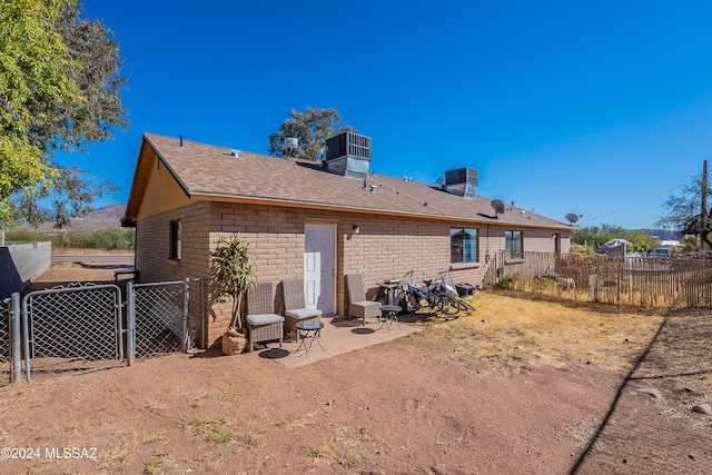 rear view of property with a patio area and central AC unit