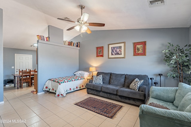 tiled bedroom with ceiling fan and lofted ceiling