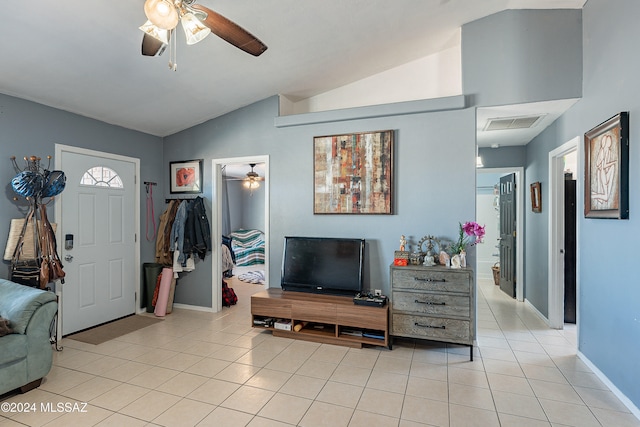 entryway with vaulted ceiling and light tile patterned flooring