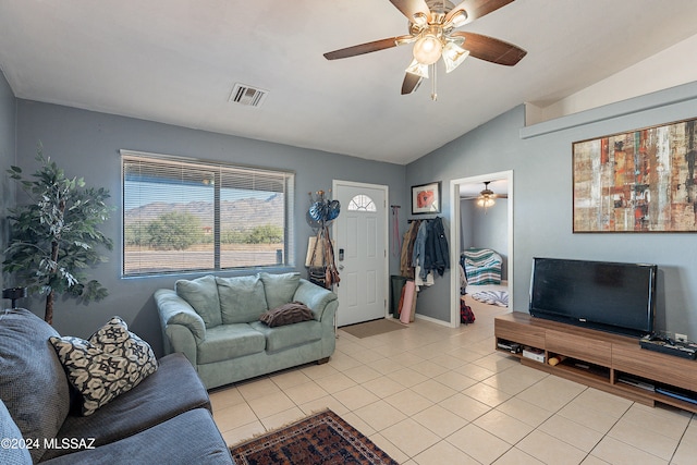 living room featuring light tile patterned floors and vaulted ceiling