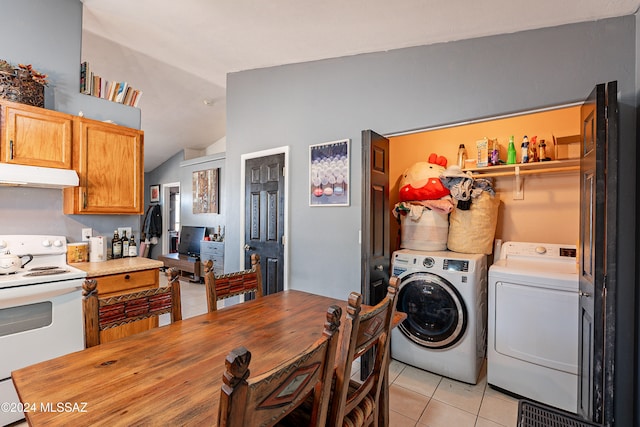 kitchen with washer and clothes dryer, light tile patterned floors, white electric range, butcher block countertops, and lofted ceiling