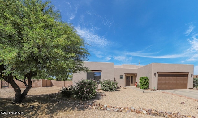 pueblo-style home with a garage