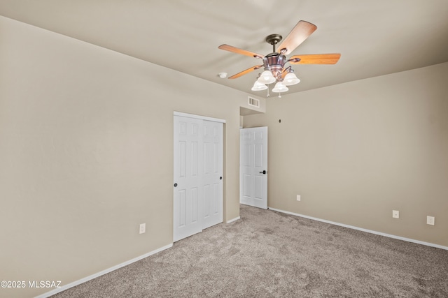 carpeted empty room featuring ceiling fan