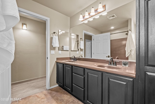 bathroom with tile patterned flooring and vanity