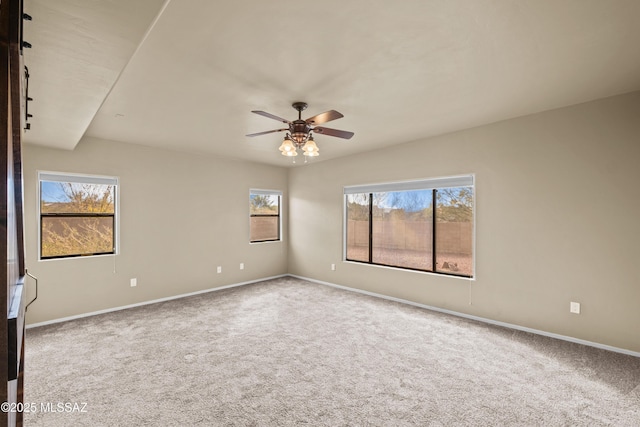 carpeted spare room featuring ceiling fan