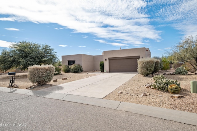 pueblo-style home with a garage