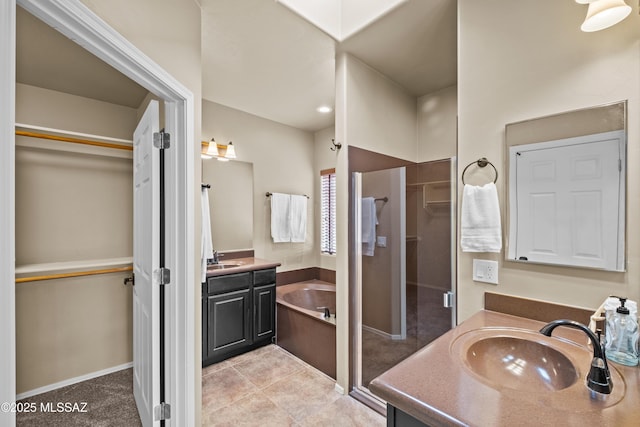 bathroom with tile patterned flooring, vanity, and a tub