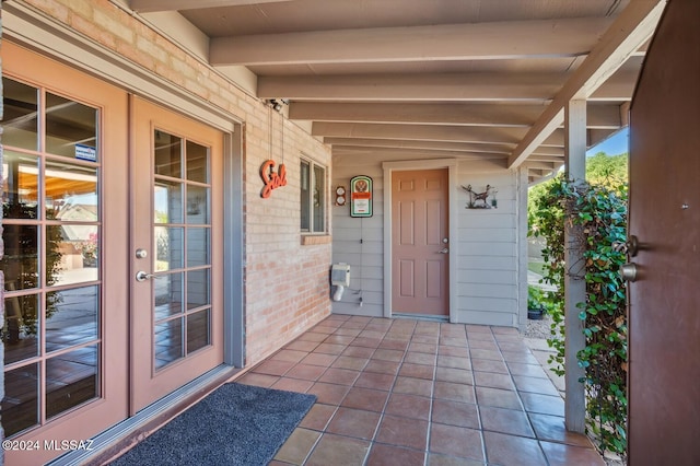 entrance to property featuring french doors and covered porch