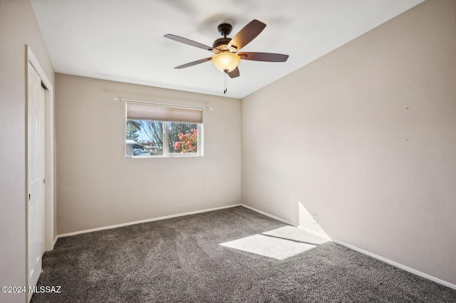 unfurnished bedroom with dark colored carpet, a closet, and ceiling fan