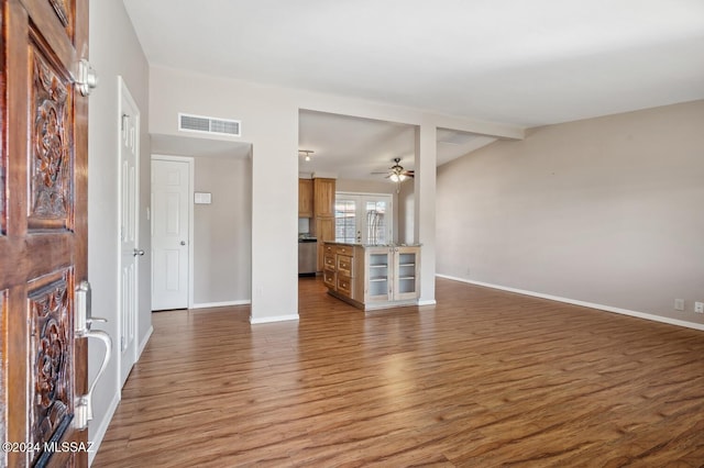 unfurnished living room with ceiling fan, wood-type flooring, french doors, and lofted ceiling