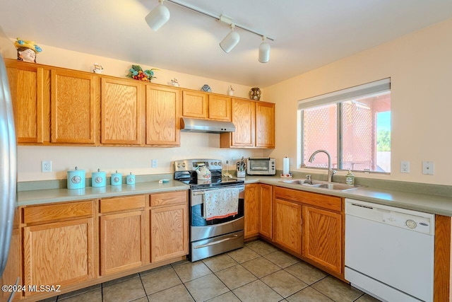 kitchen with sink, light tile patterned floors, stainless steel appliances, and track lighting