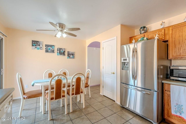 tiled dining area featuring ceiling fan