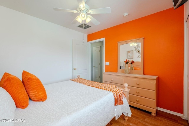 bedroom featuring wood-type flooring and ceiling fan