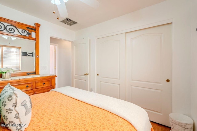 bedroom featuring ceiling fan, a closet, and hardwood / wood-style floors