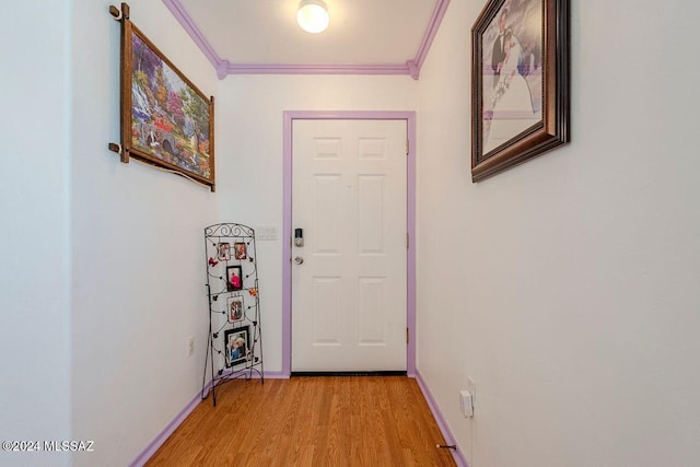 corridor with crown molding and light hardwood / wood-style floors