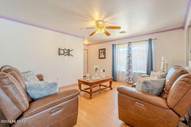 living room featuring ceiling fan, light wood-type flooring, and ornamental molding