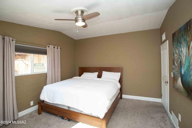 bedroom with ceiling fan, light colored carpet, and vaulted ceiling