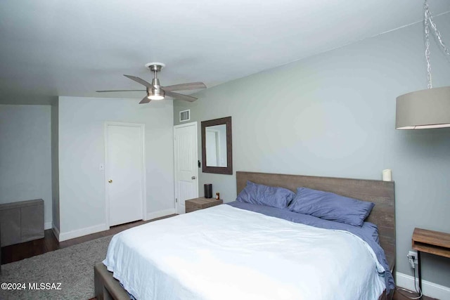 bedroom featuring dark hardwood / wood-style floors and ceiling fan