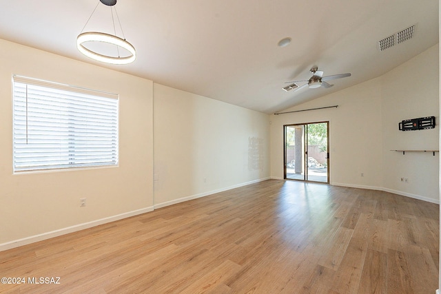 empty room featuring vaulted ceiling, ceiling fan, and light wood-type flooring