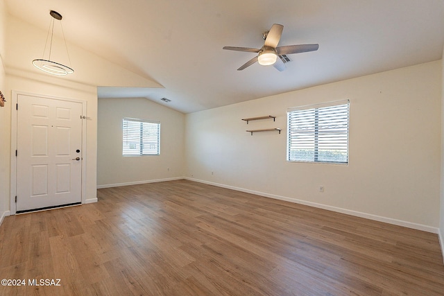 interior space with hardwood / wood-style flooring, lofted ceiling, and ceiling fan