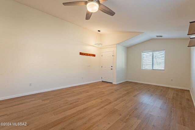 interior space with vaulted ceiling, ceiling fan, and light wood-type flooring